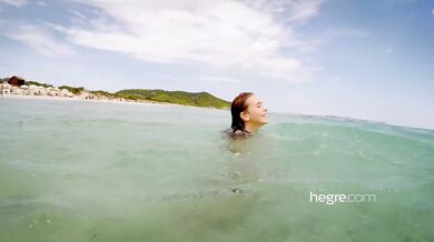 Alisa Amore nude on the beach and in the sea